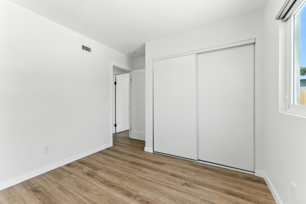10021 Allenwood Way Santee, CA 92071 - Photo 18 of 28 a view of an empty room with wooden floor and a window