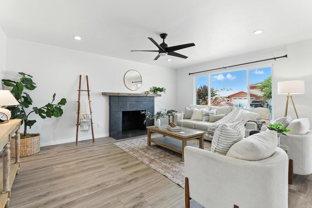 10021 Allenwood Way Santee, CA 92071 - Photo 3 of 28 a living room with furniture a fireplace and a potted plant