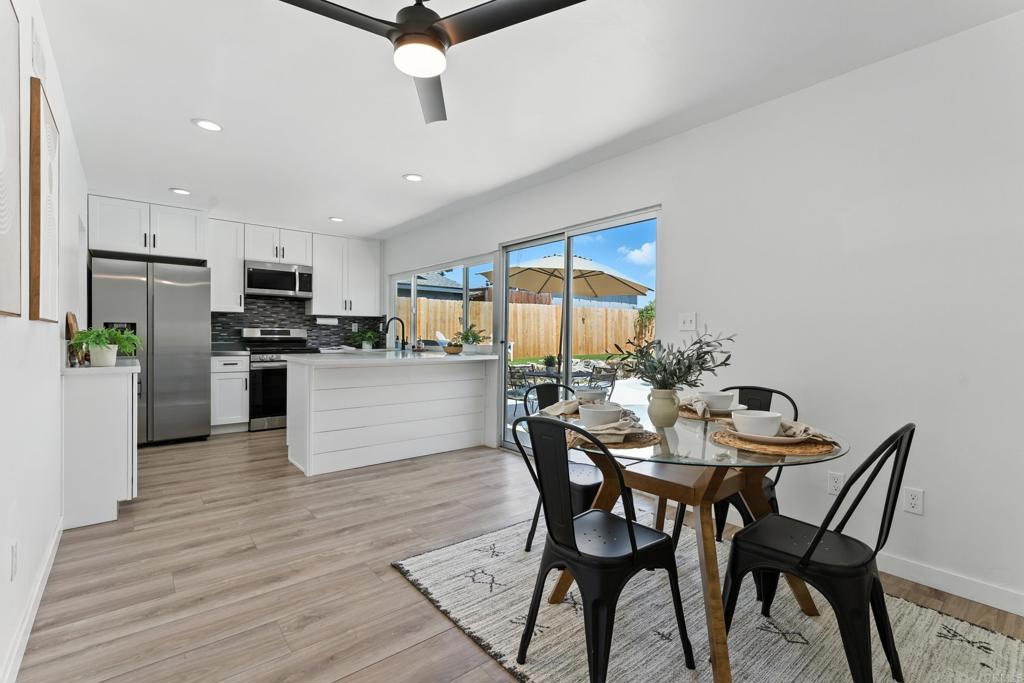 10021 Allenwood Way Santee, CA 92071 - Photo 6 of 28 a kitchen with a table chairs refrigerator and microwave