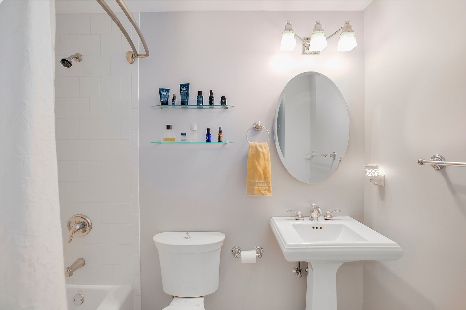 4144 North Sheridan Road, Unit 208 Chicago, IL 60613 - Photo 17 of 24 a bathroom with a sink a toilet and mirror