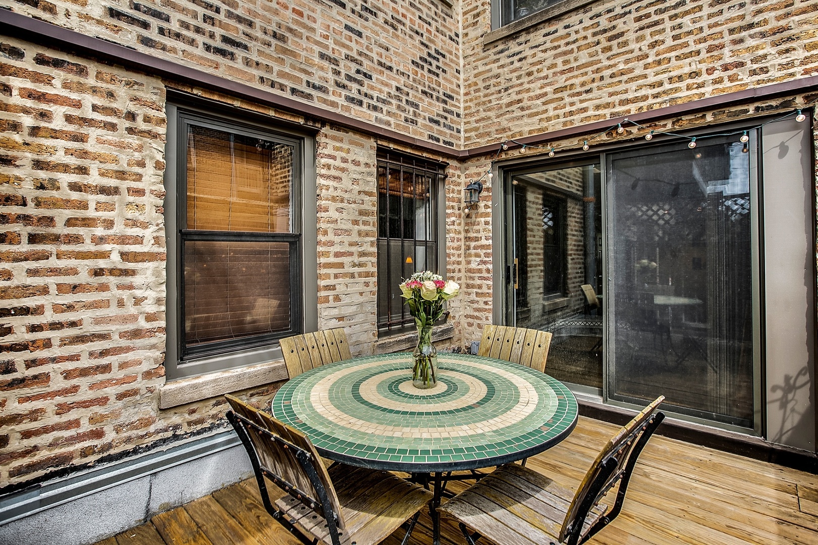 4144 North Sheridan Road, Unit 208 Chicago, IL 60613 - Photo 19 of 24 a view of a balcony with table and chairs