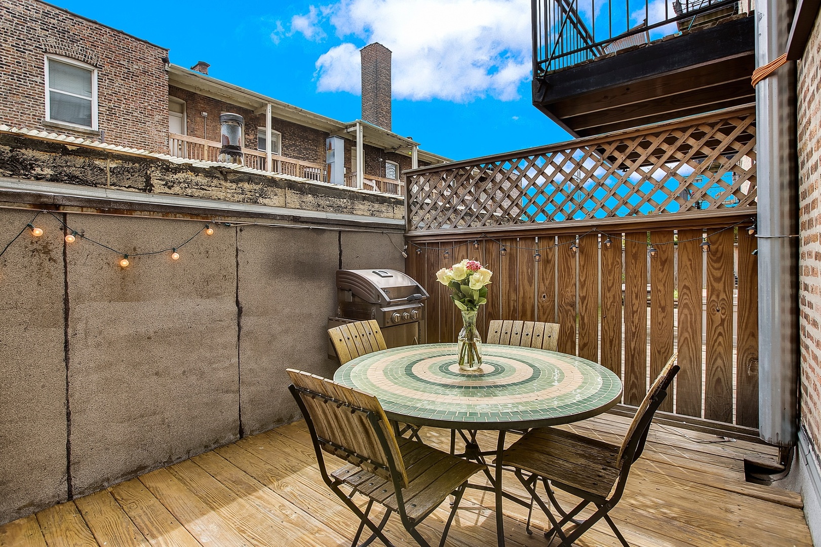 4144 North Sheridan Road, Unit 208 Chicago, IL 60613 - Photo 20 of 24 a table and chairs sitting in front of a house