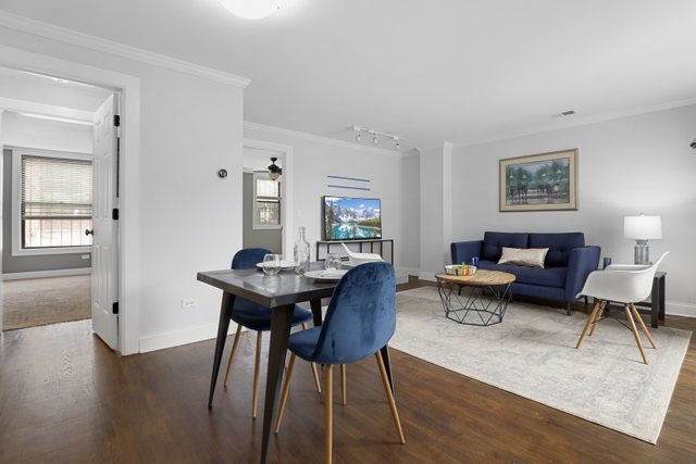 4144 North Sheridan Road, Unit 208 Chicago, IL 60613 - Photo 6 of 24 a view of a dining room with furniture and wooden floor