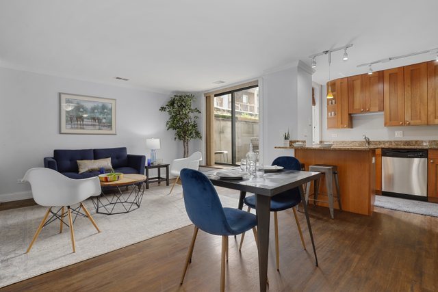 4144 North Sheridan Road, Unit 208 Chicago, IL 60613 - Photo 7 of 24 a view of a dining room with furniture and wooden floor