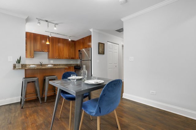 4144 North Sheridan Road, Unit 208 Chicago, IL 60613 - Photo 8 of 24 a view of a dining room with furniture and wooden floor