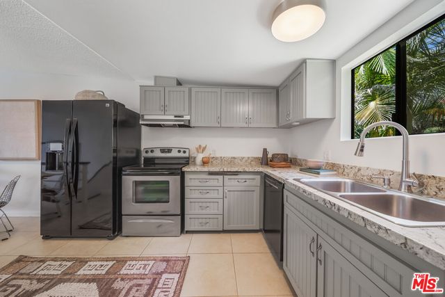 a kitchen with a sink stove and refrigerator