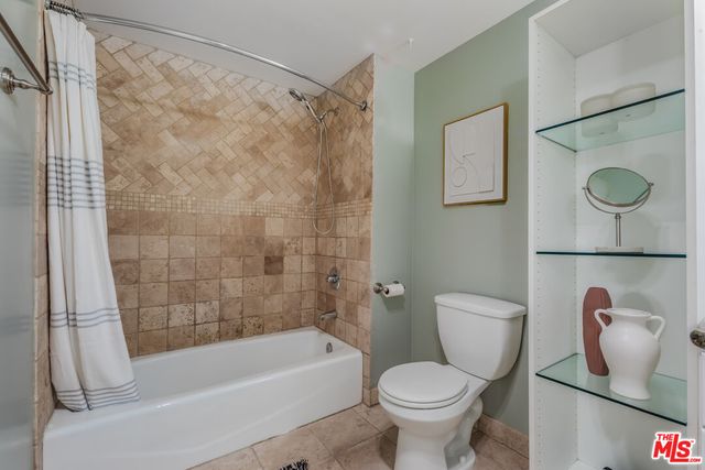 a bathroom with a toilet sink and shower