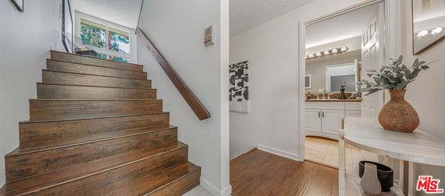 a view of entryway and hall with wooden floor