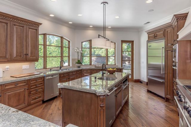 a kitchen with counter top space a sink and appliances