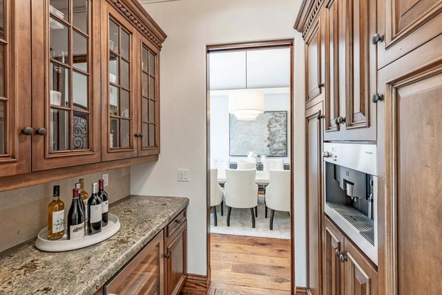 a kitchen with granite countertop a sink and a stove next to a window
