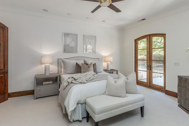 a spacious bedroom with a bed a couch and a window