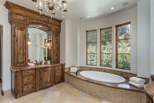 a spacious bathroom with a granite countertop tub sink and mirror