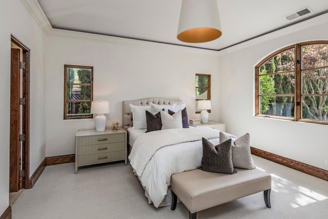 a bed room with bed and a large window