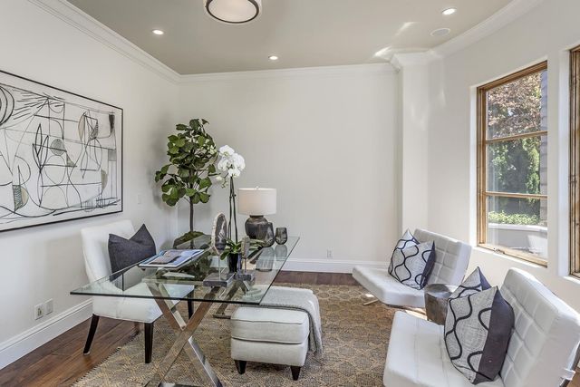 a living room with furniture and a potted plant