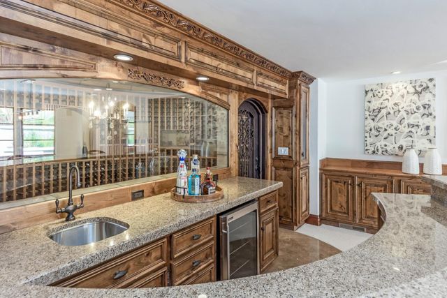 a kitchen with sink and refrigerator