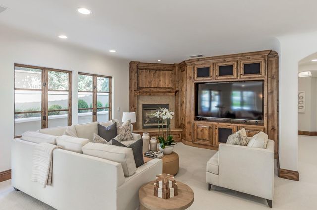 a spacious bedroom with a bed and large window