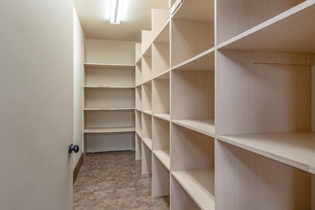 a front view of a house with swimming pool and dining space