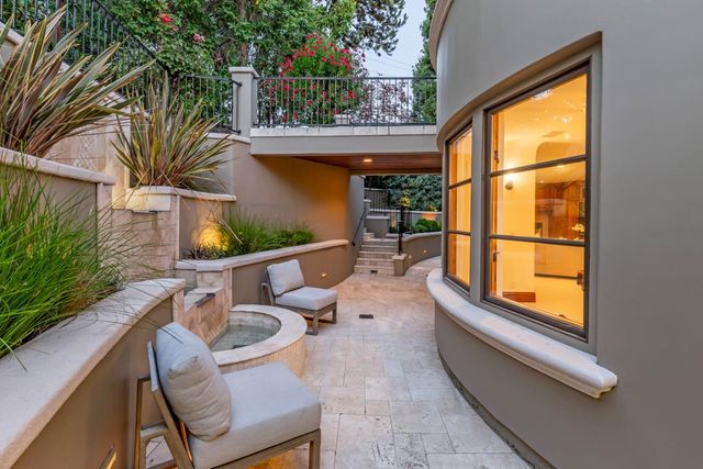 a view of a patio with table and chairs potted plants with wooden floor and fence