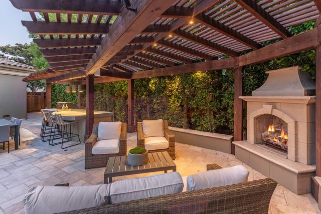 a patio with glass top table and chairs