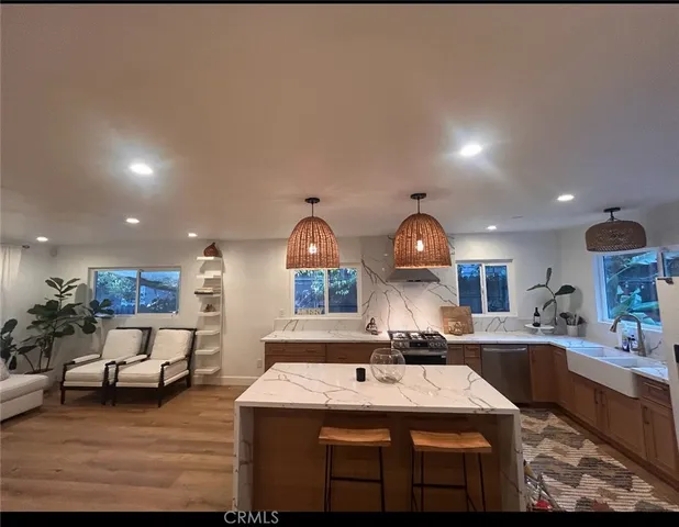 a kitchen with a sink and a stove with kitchen island