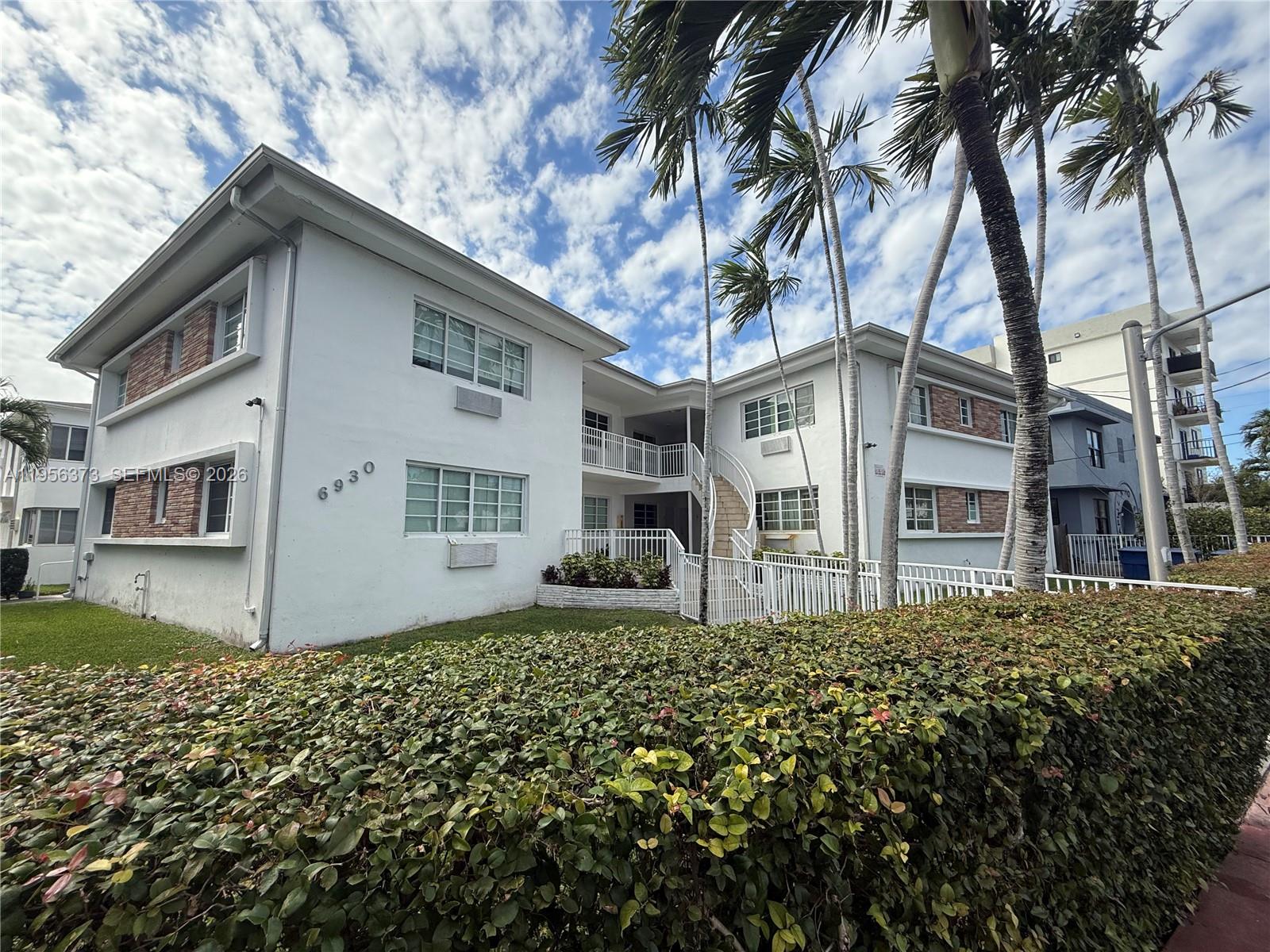 6930 Rue Vendome, Unit 3 Miami Beach, FL 33141 - Photo 1 of 14 a front view of a house with a garden