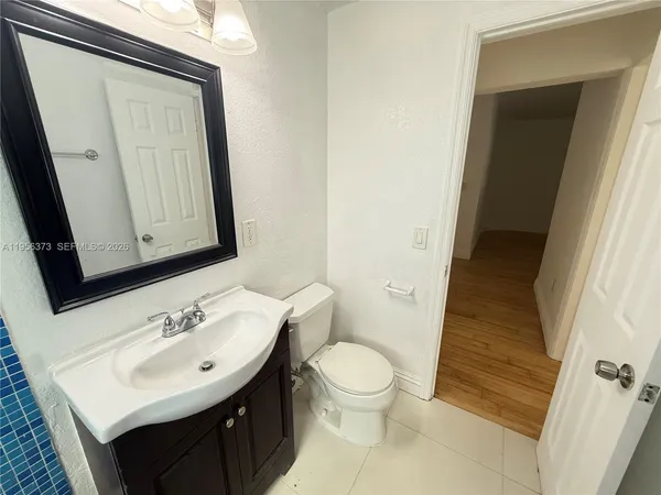 a bathroom with a sink toilet and mirror