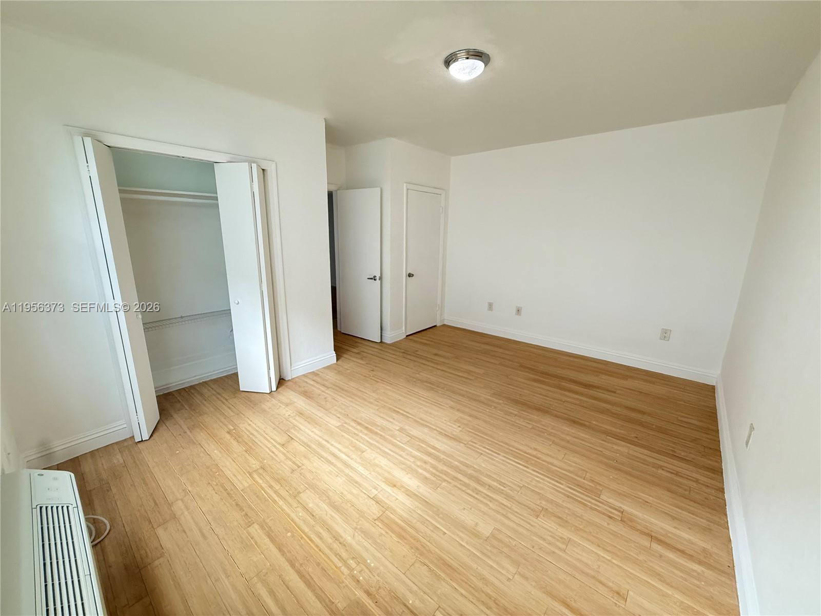 6930 Rue Vendome, Unit 3 Miami Beach, FL 33141 - Photo 13 of 14 an empty room with wooden floor and entrance