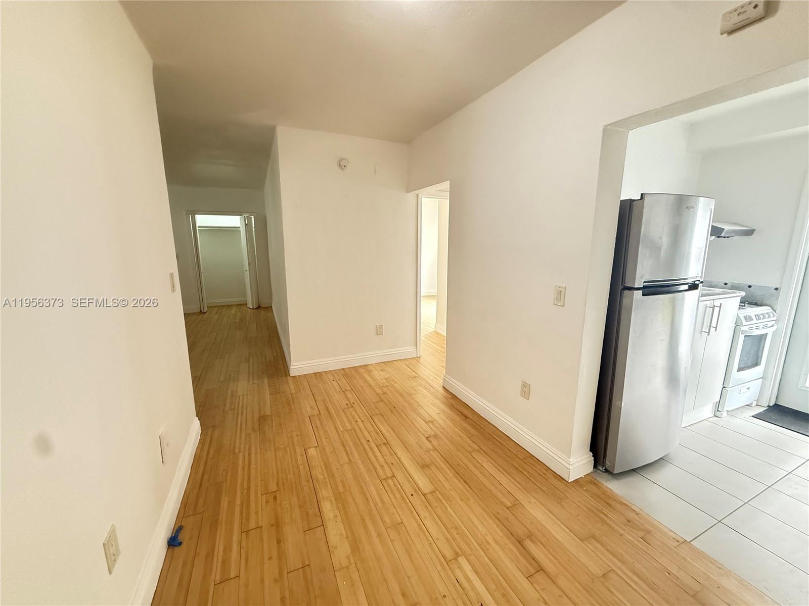6930 Rue Vendome, Unit 3 Miami Beach, FL 33141 - Photo 6 of 14 a view of a room with wooden floor and a hallway