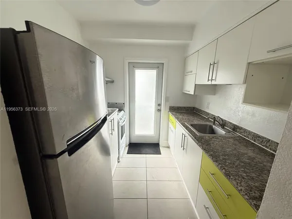 a kitchen with a refrigerator a sink and dishwasher