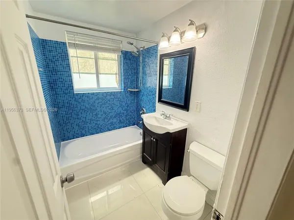 a bathroom with a sink a toilet and bathtub