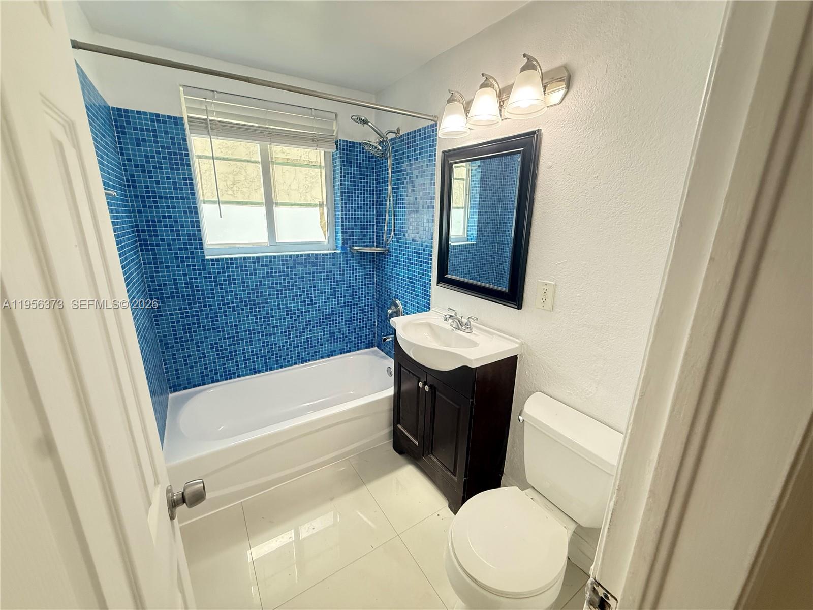 6930 Rue Vendome, Unit 3 Miami Beach, FL 33141 - Photo 10 of 14 a bathroom with a sink a toilet and bathtub