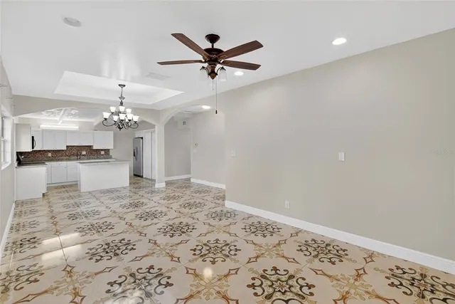 a view of a kitchen with a sink and a chandelier