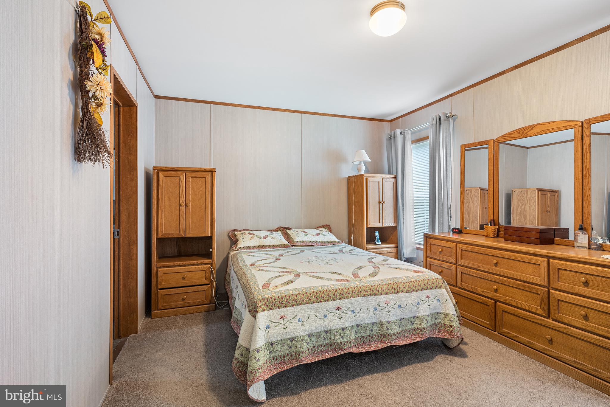 474 Barrington Road Macungie, PA 18062 - Photo 18 of 28 a bedroom with a bed and a dresser with mirror