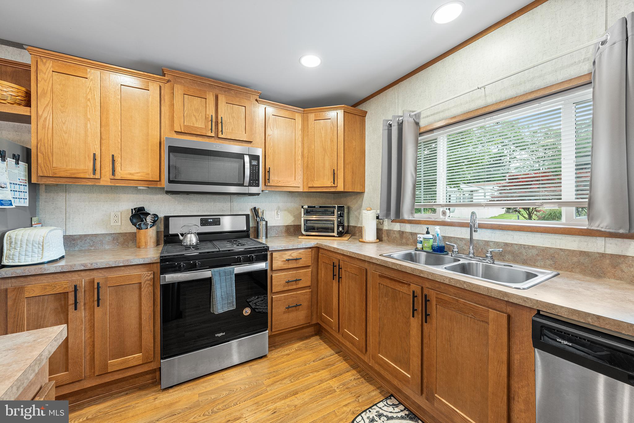 474 Barrington Road Macungie, PA 18062 - Photo 10 of 28 a kitchen with stainless steel appliances granite countertop a sink a stove a microwave cabinets and a window