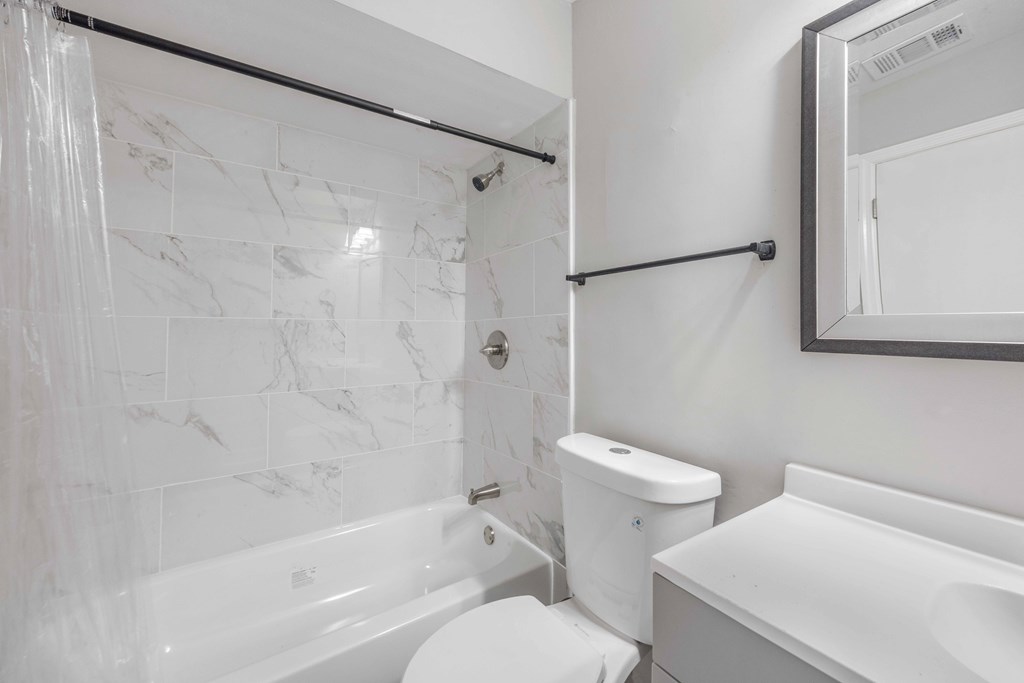 5100 Buckingham Court Columbus, GA 31907 - Photo 15 of 24 a white toilet sitting next to a bath tub and a shower