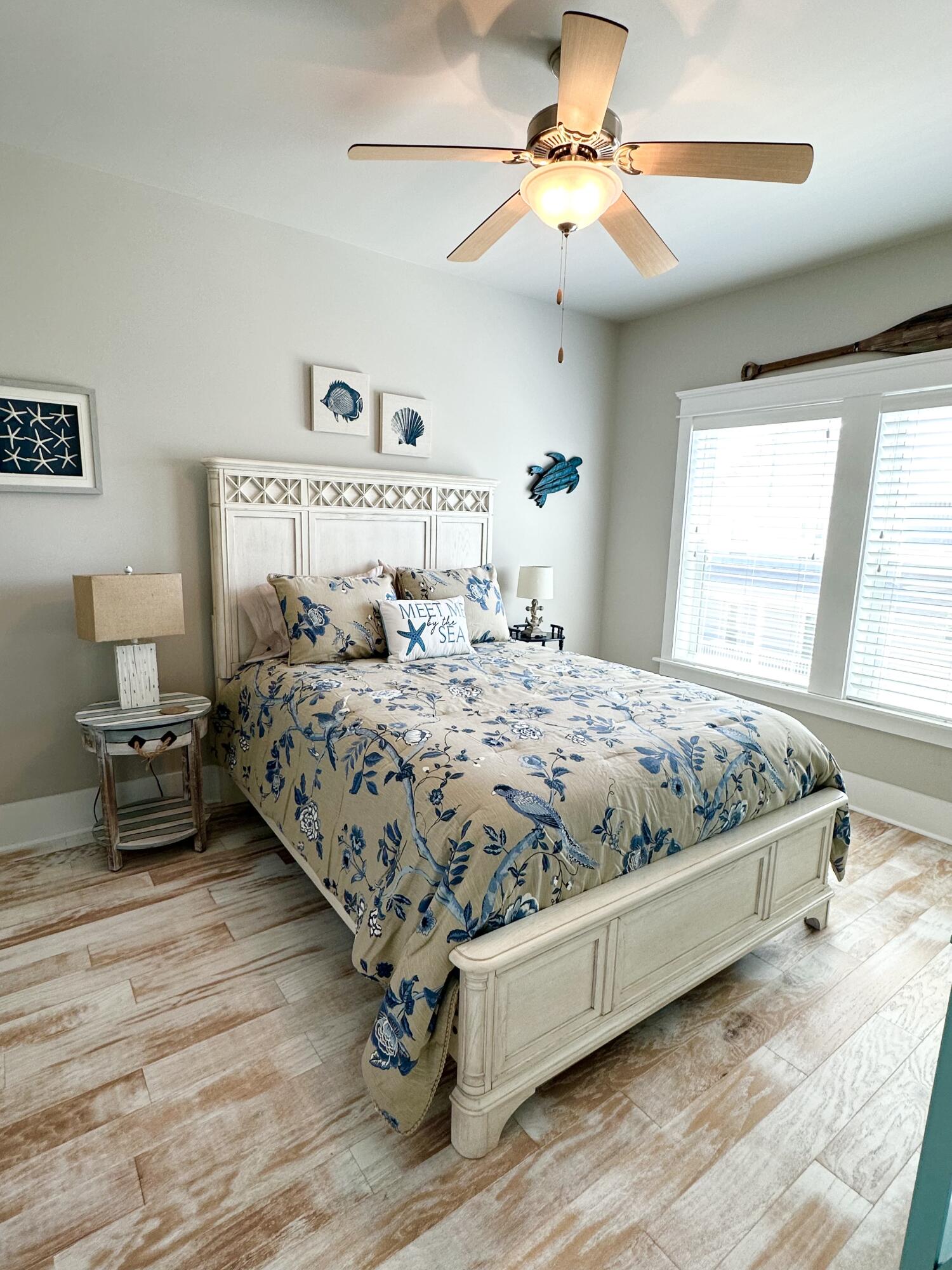 1422 Seaside Circle Navarre, FL 32566 - Photo 11 of 42 a bedroom with a large bed and a chandelier