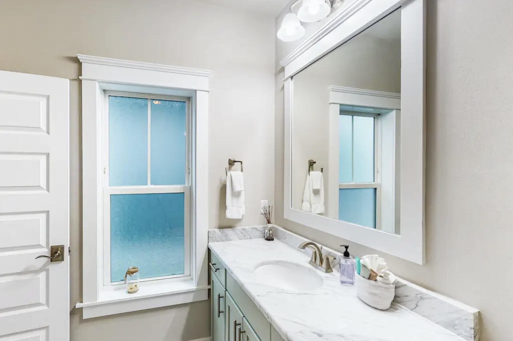 1422 Seaside Circle Navarre, FL 32566 - Photo 13 of 42 a bathroom with a sink and a mirror