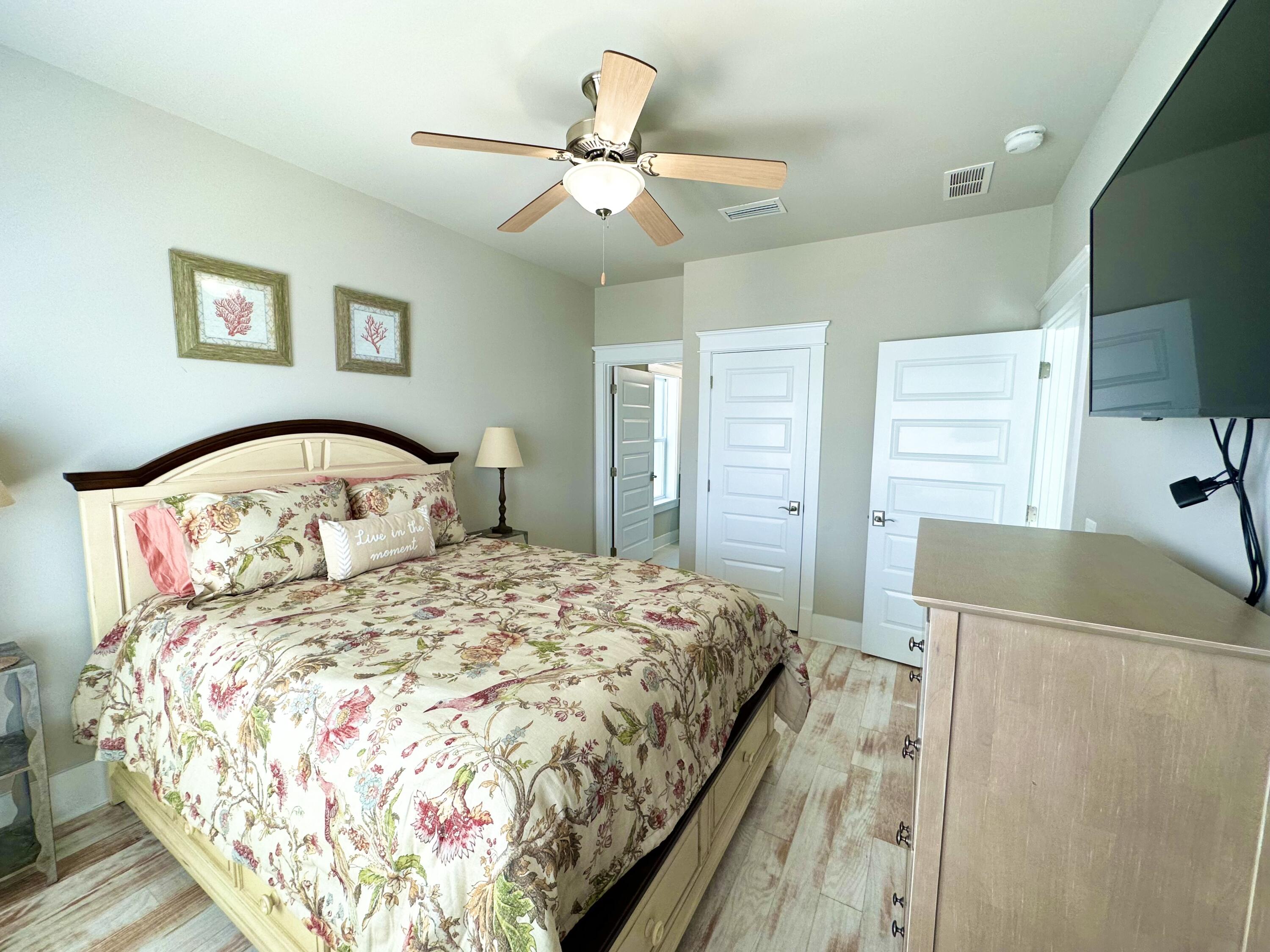 1422 Seaside Circle Navarre, FL 32566 - Photo 15 of 42 a bedroom with a bed and a flat screen tv