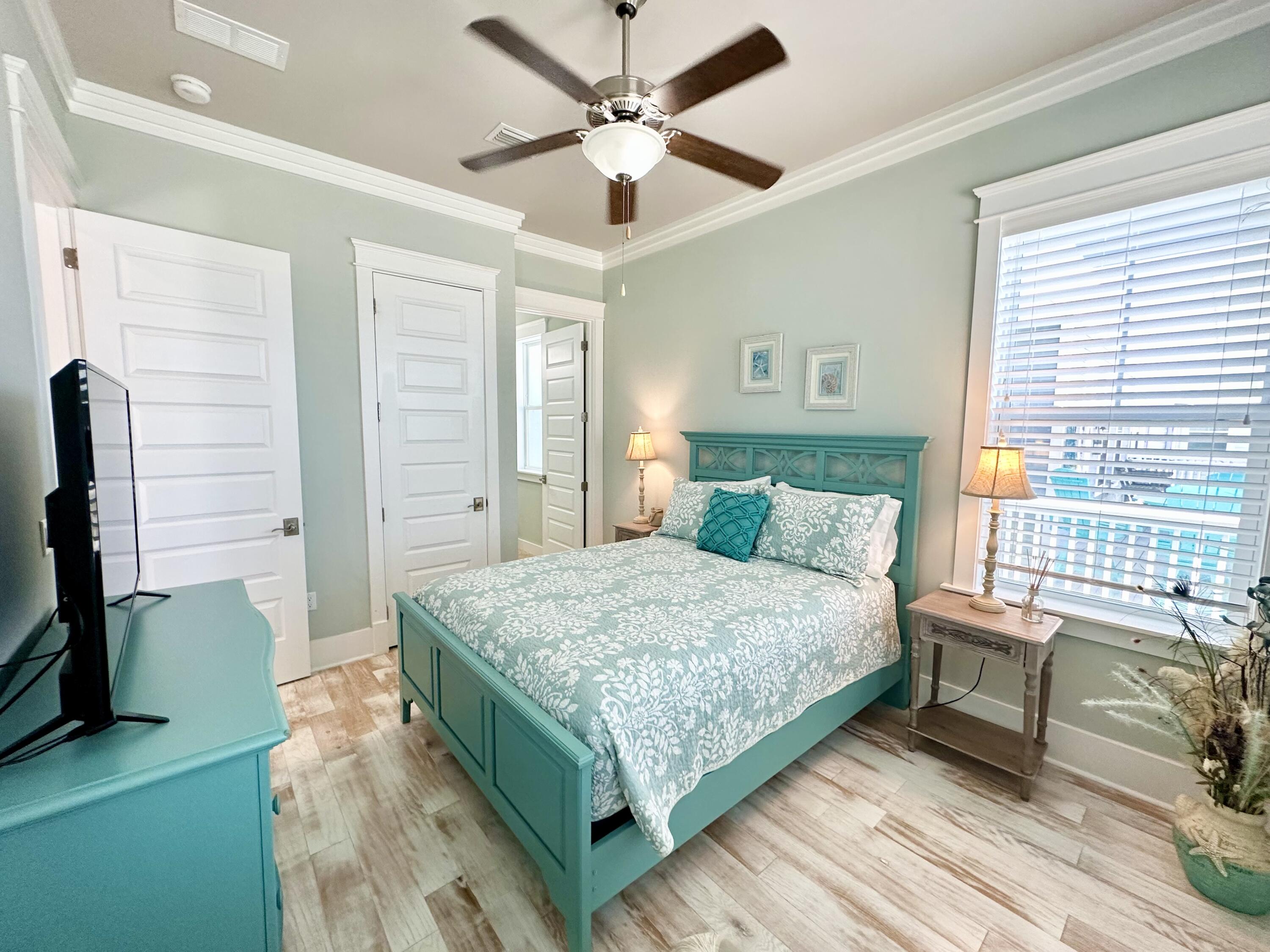 1422 Seaside Circle Navarre, FL 32566 - Photo 17 of 42 a bedroom with a bed and a chandelier