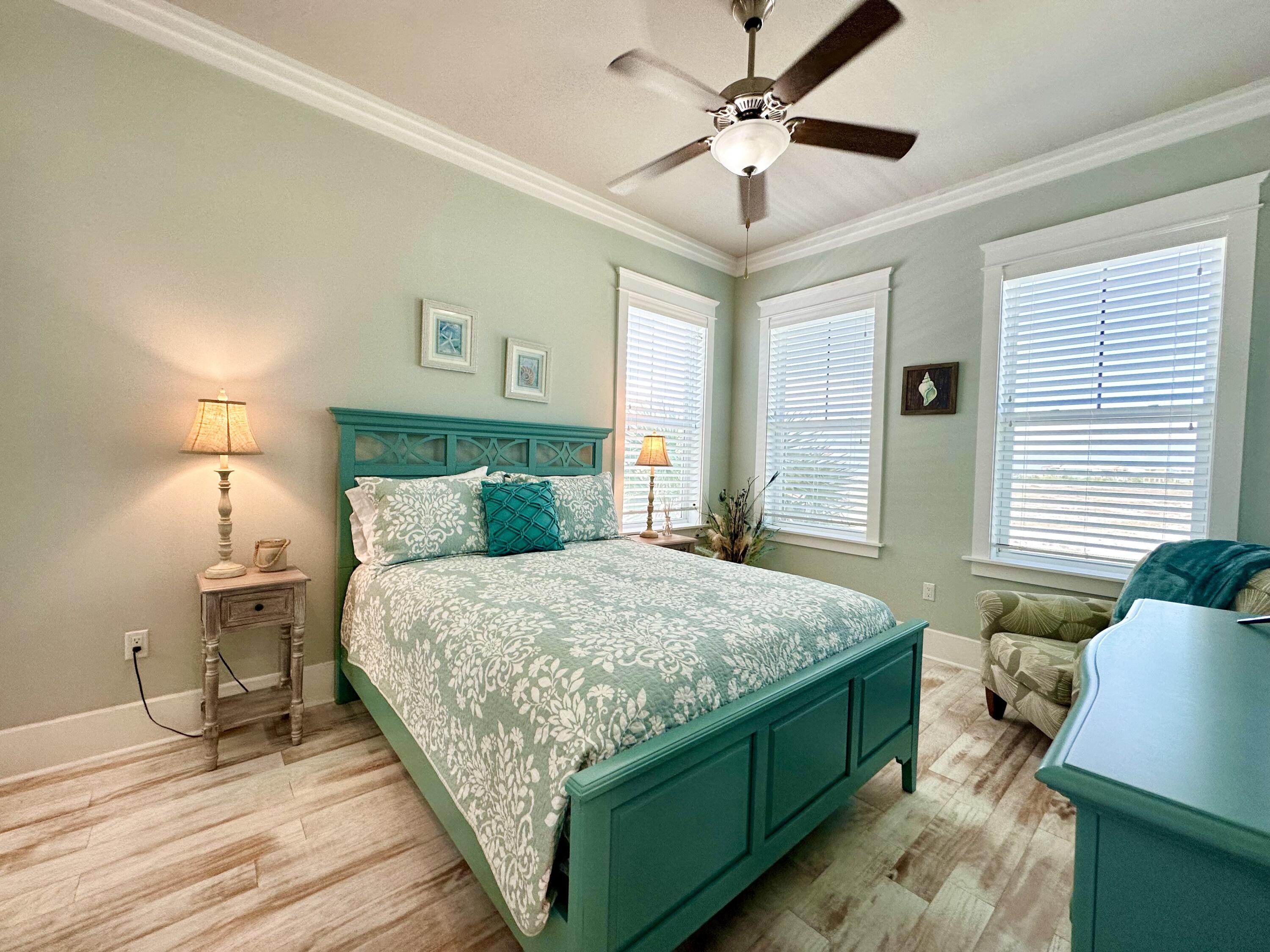 1422 Seaside Circle Navarre, FL 32566 - Photo 18 of 42 a bedroom with a bed and a chandelier