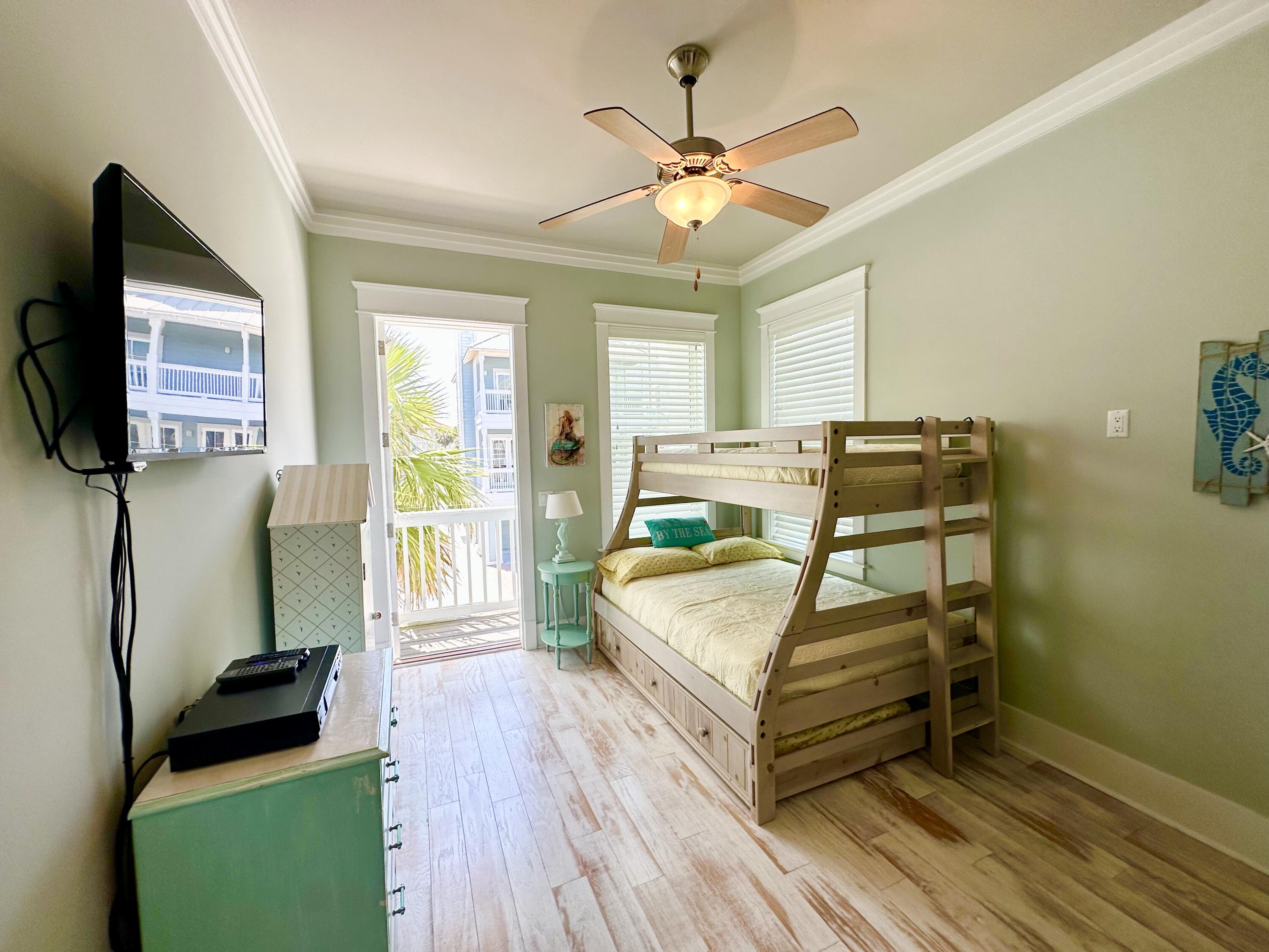1422 Seaside Circle Navarre, FL 32566 - Photo 24 of 42 a bedroom with a bed and a flat screen tv