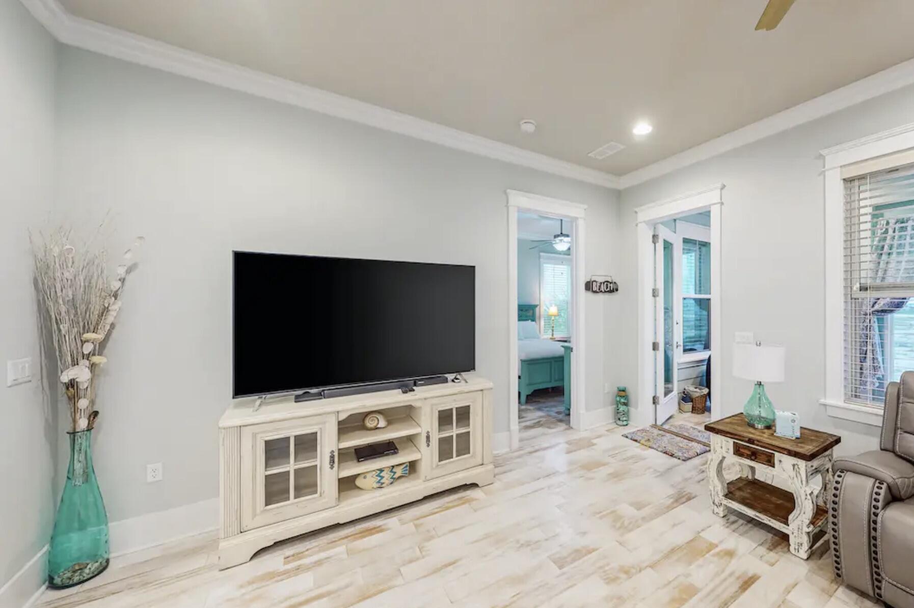 1422 Seaside Circle Navarre, FL 32566 - Photo 5 of 42 a living room with furniture and a flat screen tv