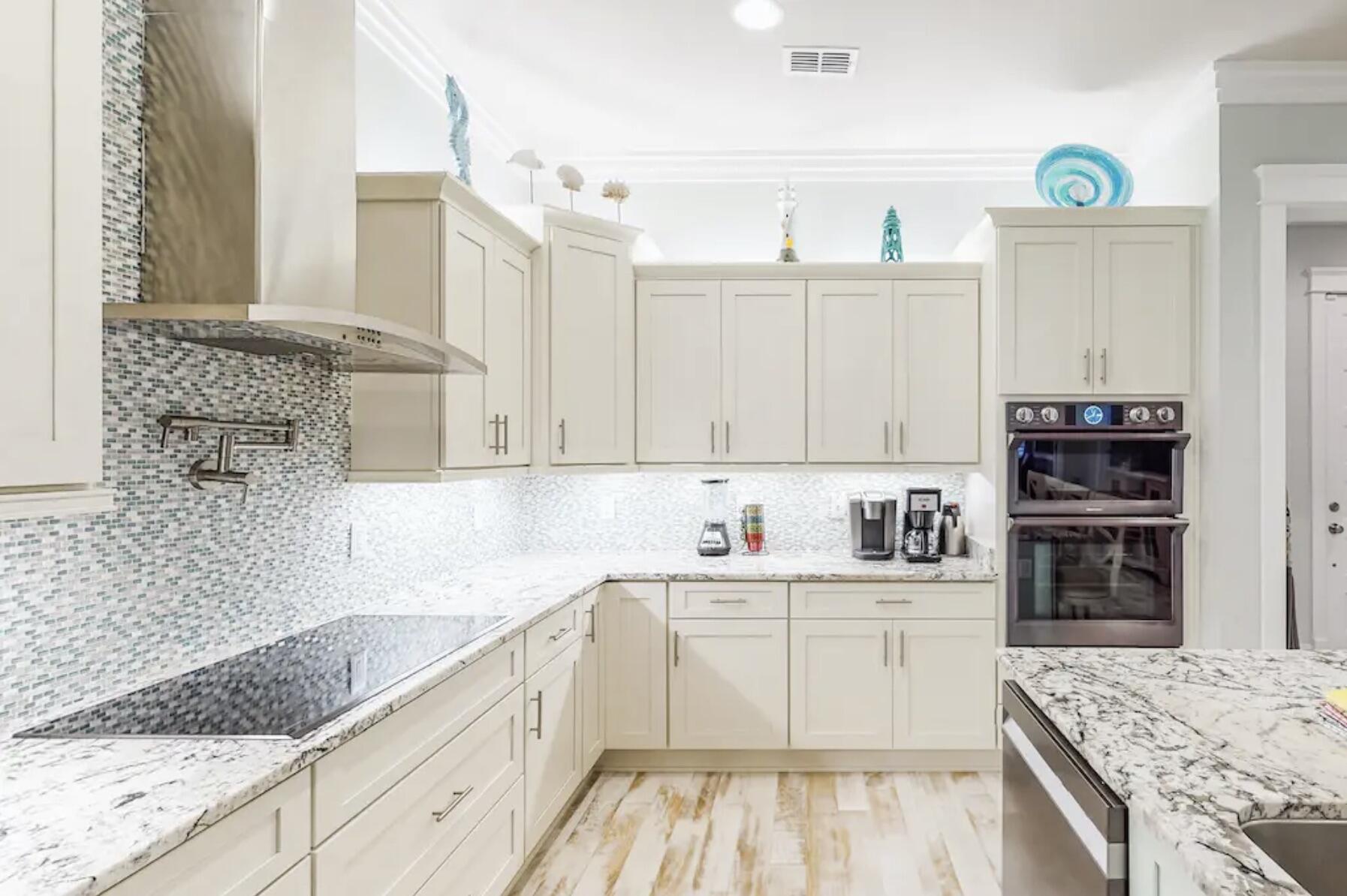 1422 Seaside Circle Navarre, FL 32566 - Photo 9 of 42 a kitchen with a sink stove and cabinets