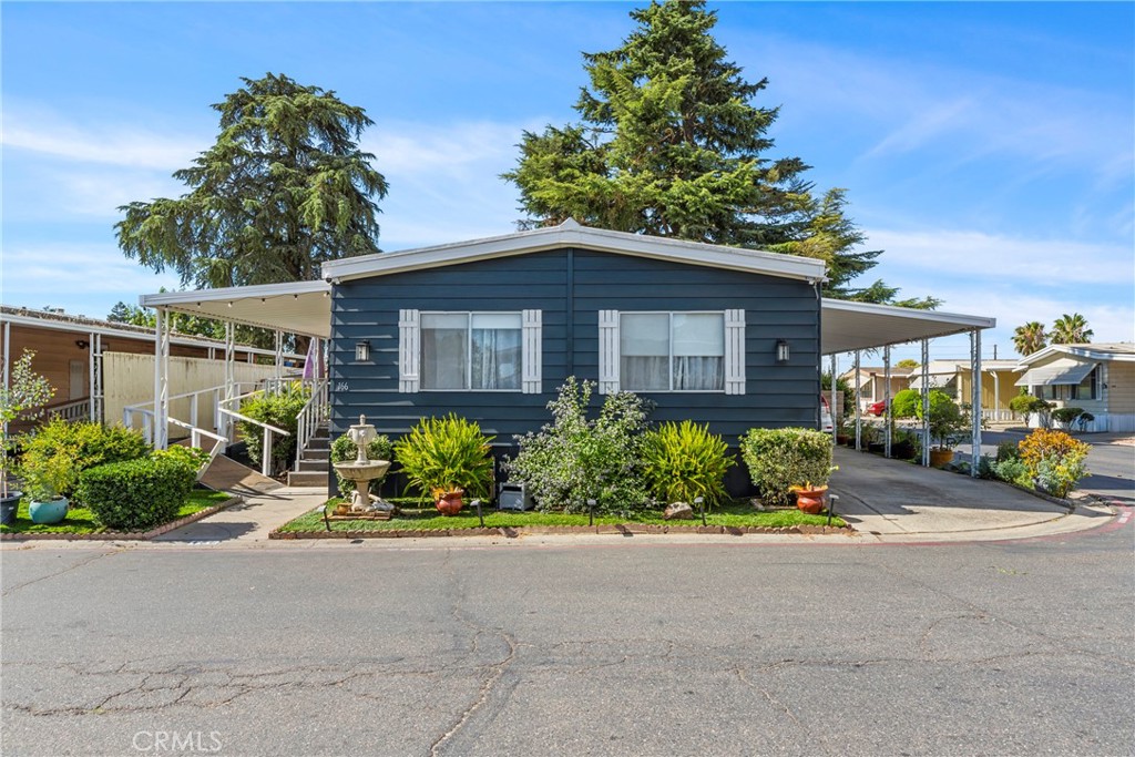 4837 Faith Home Road, Unit 166 Ceres, CA 95307 - Photo 1 of 1 a front view of a house with a yard and outdoor seating