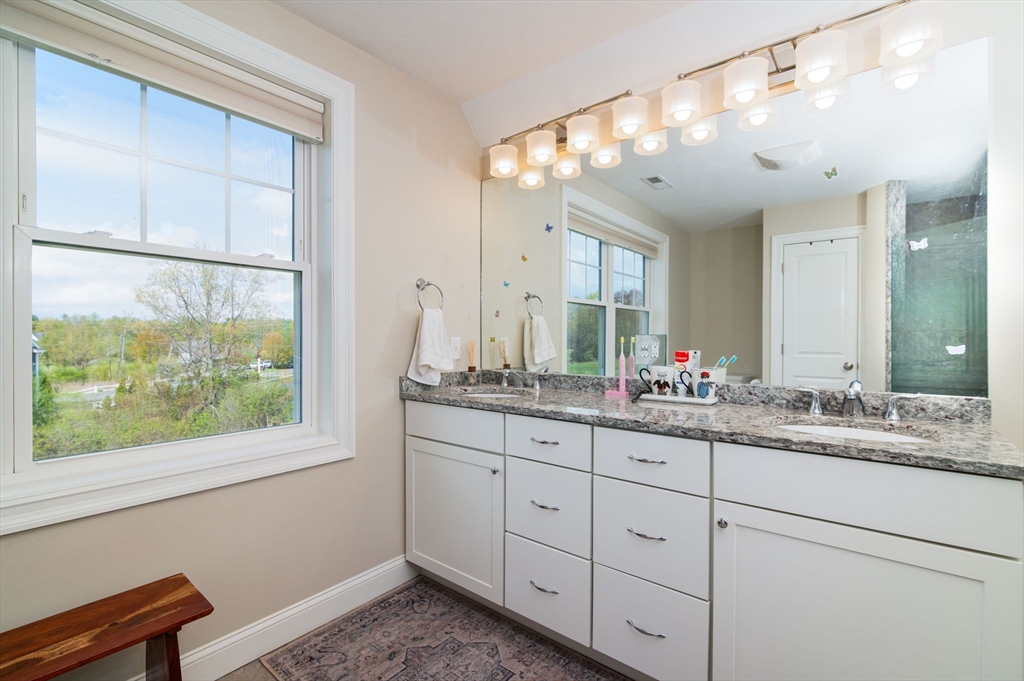 51 Tamarack Road Dracut, MA 01826 - Photo 18 of 39 a bathroom with a double vanity sink and a window