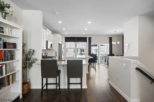 a kitchen with kitchen island granite countertop a stove sink and refrigerator