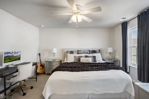 a bedroom with a large bed and a flat screen tv