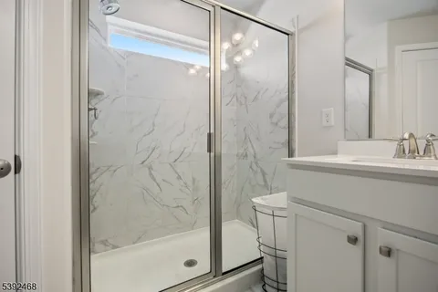 a bedroom with furniture and a large window