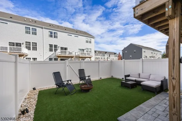 a backyard of a house with table and chairs
