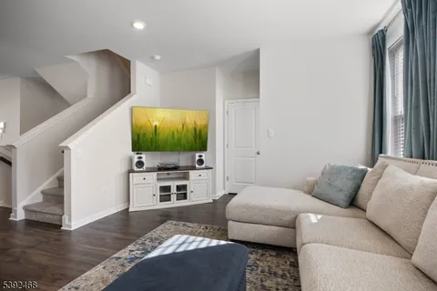 a view of living room with furniture and book shelf